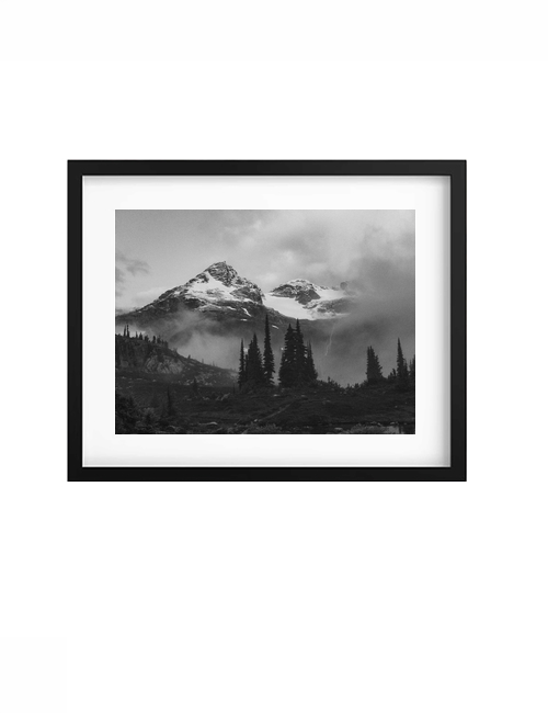 Black-framed Veil print with a white mat, showing misty mountains in black and white.