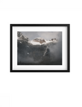 Black-framed Cascade print with a white mat, showing an alpine waterfall beneath snowy peaks.