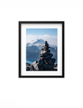 Black-framed Heights print with a white mat, showing a stone cairn and mountain view.