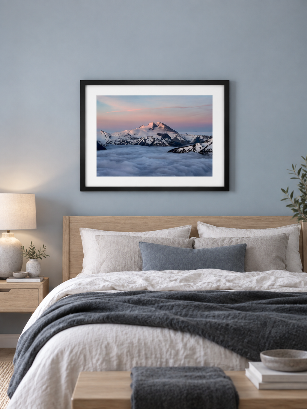 Room mockup of Inversion above a bed against a blue-gray wall.